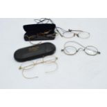 A collection of Georgian or similar style spectacles / glasses with rolled gold frames, some cased.