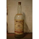 A large vintage Bells Old Scotch Whiskey bottle. 51cm tall.