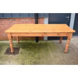 A late 20th century thick pine topped kitchen table. 198 x 86 x 78cm tall. In good functional