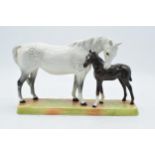 Beswick Mare and Foal - grey mare with dark brown foal on ceramic grass base 1811. In good condition
