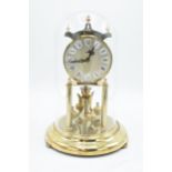 A 20th century anniversary clock with dome made by Kieninger & Obergfell with key. Appears to be