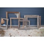 A collection of various shaped oak and similar hardwood picture frames with the largest being 92 x