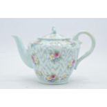 Paragon Fine China teapot with floral decoration on a light blue / duck egg green background. In