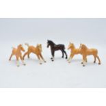 A collection of Beswick foals to include palomino examples and a brown example (5). In good
