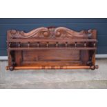 An early 20th century wooden shelving unit / spice shelf with carved decoration and turned features.