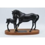 Beswick Black Beauty and Foal on wooden base. In good condition no obvious damage or restoration.