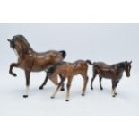 A trio of brown Beswick horses to include leg tucked horse 1549, mare facing right 991 and a large