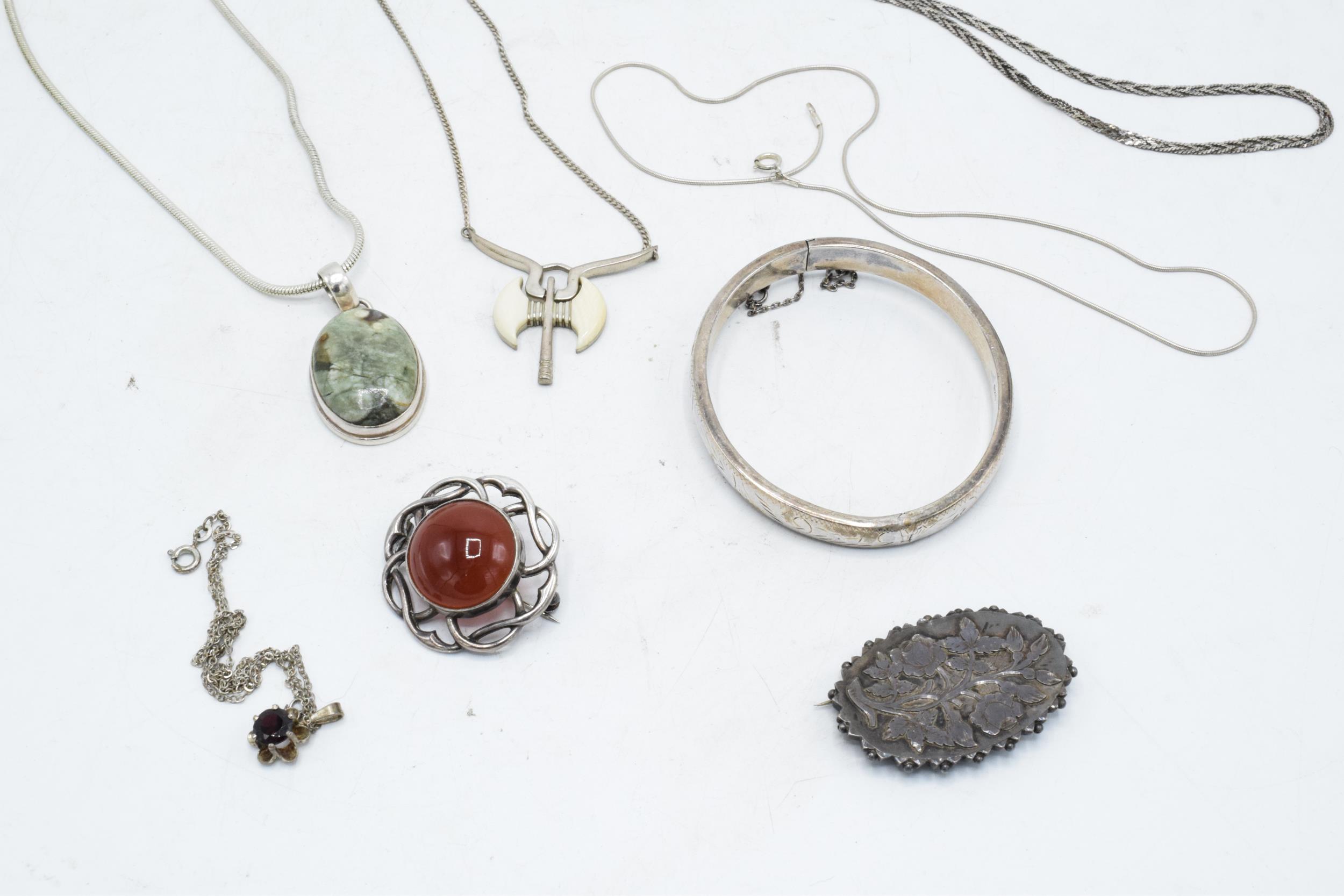 A collection of silver jewellery to include brooches, chains, pendants etc. Gross weight 73.7 grams.