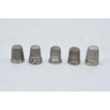 A collection of 5 silver thimbles to include 3 hallmarked, 1 sterling and 1 tested as silver (5).