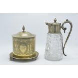 An ornate silver-plated and glass claret jug together with a silver plated biscuit barrel raised