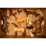 A collection of Beswick horses to include brown 818 shire, highland pony, palomino prancing arab and