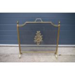 A brass and metal fire guard with armorial or similar badge to front. 67 x 68cm tall.