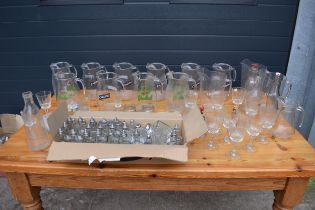 A large collection of mainly glassware to include pub jug such as Carling and Gorlsch, condiment