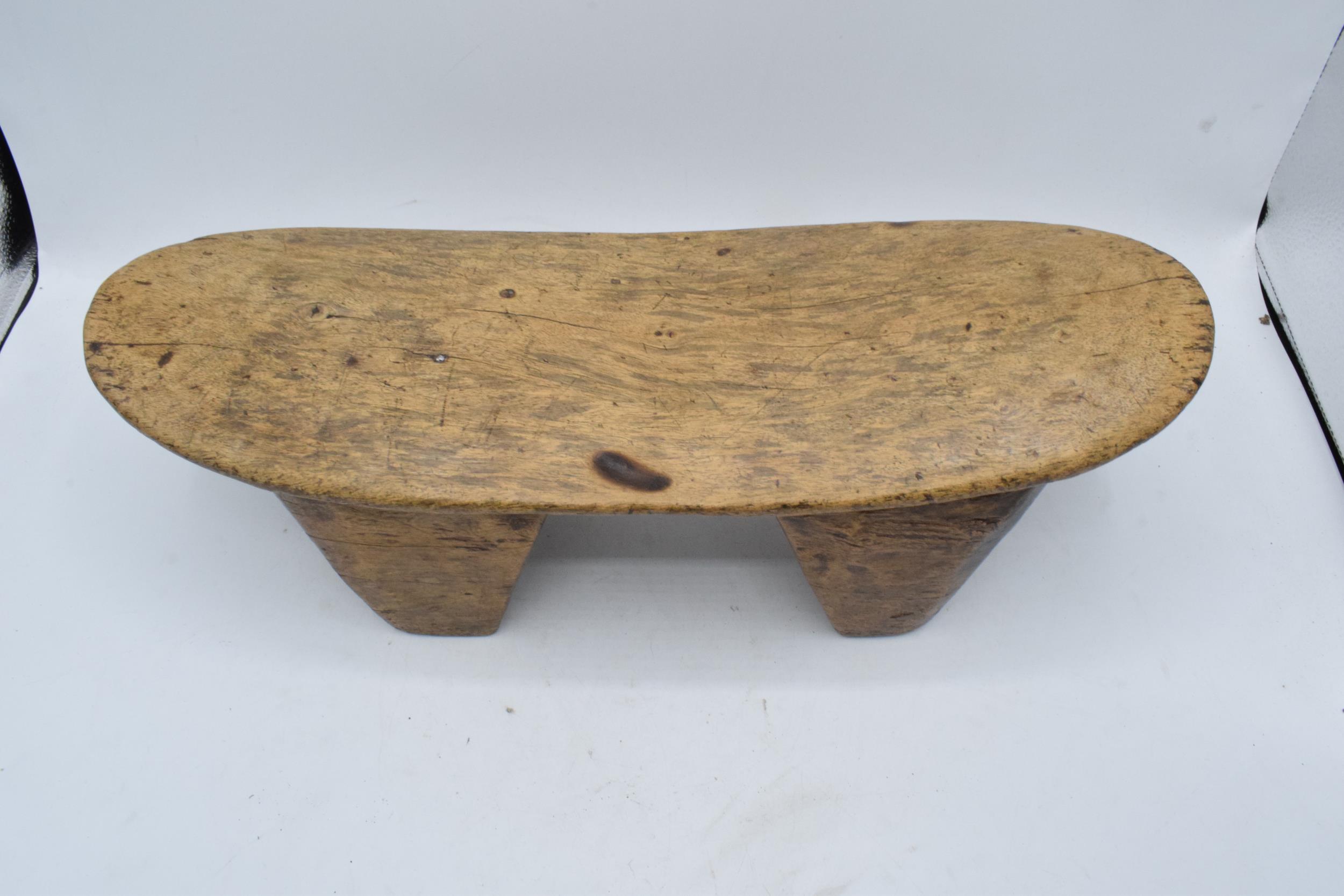 An early to mid 20th carved wooden headrest, believed to be of African origin. 43cm long. - Image 2 of 3