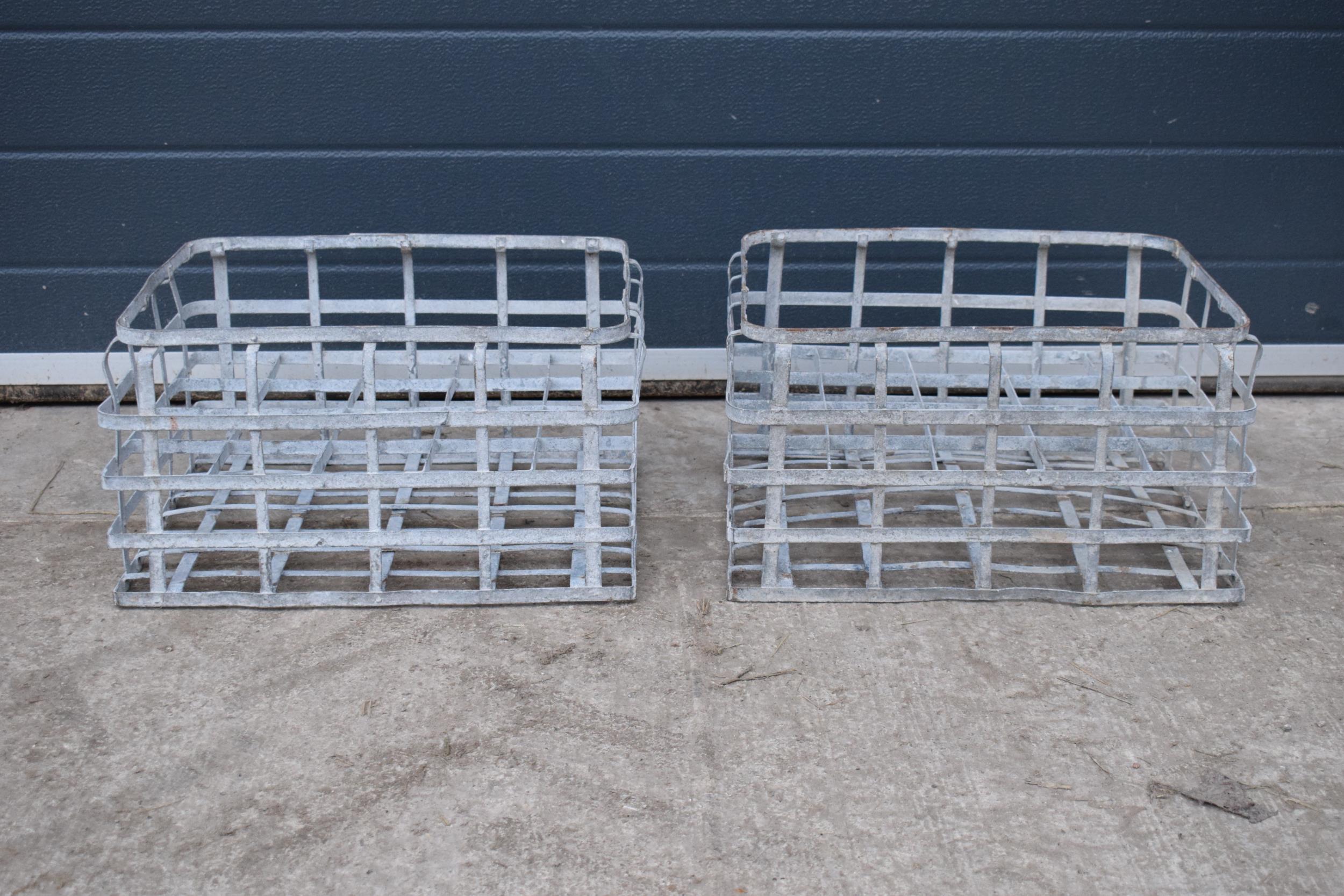 A pair of vintage metal stacking milk crates. Each to hold 16 bottles. Approx 44 x 35cm.