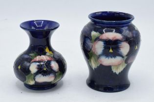 A pair of Moorcroft vases in the pansy design, both a/f. Tallest 11cm tall.