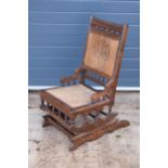 Edwardian wooden spring-action American-style rocking chair with turned decoration. 96cm tall. In