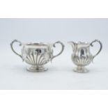 A silver sugar bowl and matching cream jug with raised decoration. Birmingham 1896. 260.3 grams.