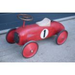 A vintage retro 20th century children?s tinplate racing car in a red colourway with number '1' to
