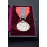 A cased George V 'For Faithful Service' medal awarded to Harry Nicholas Hillier.