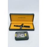 A pair of Caterham items to include a cased ball point pen together with a cased Caterham 8GB USB