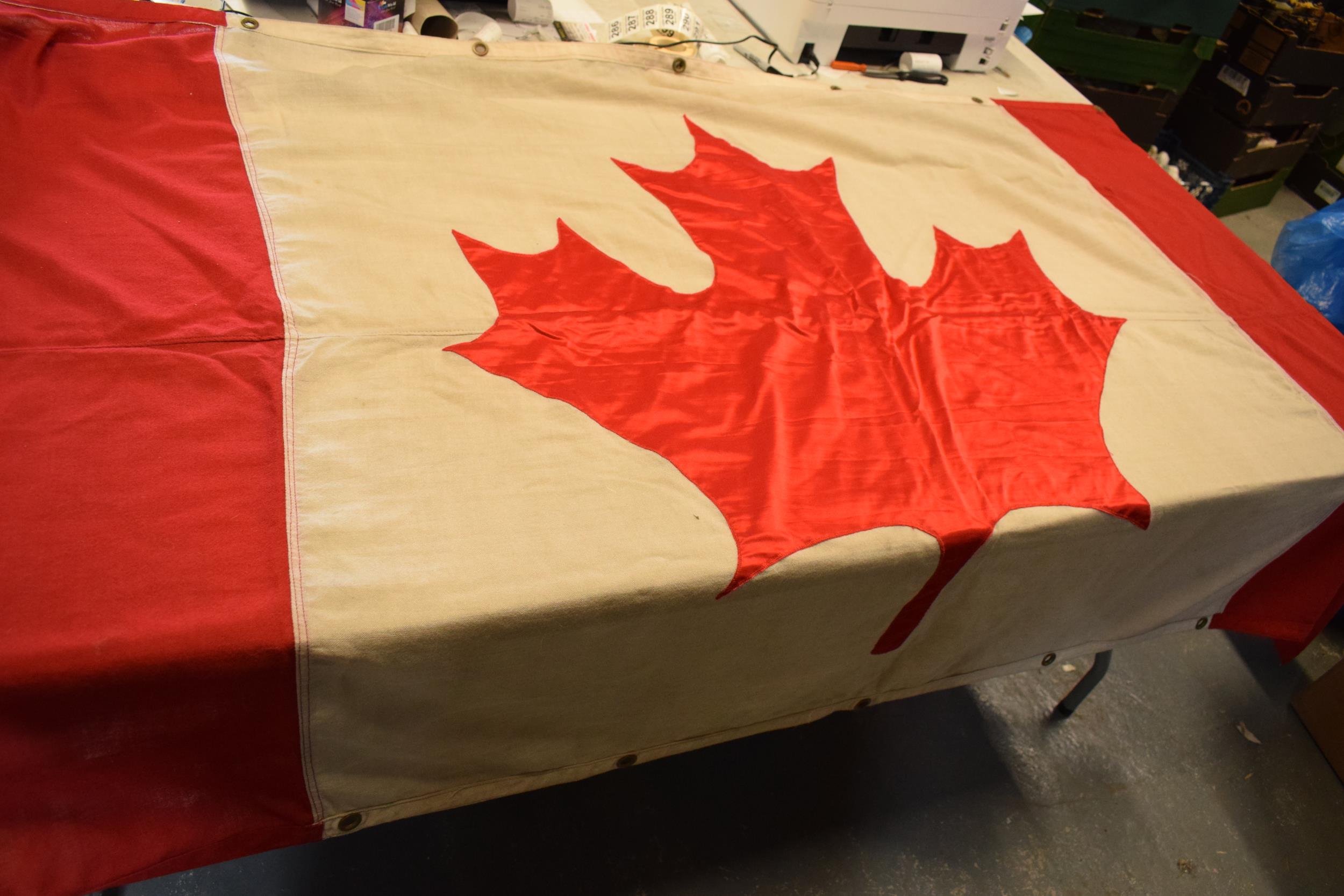 A large 1960s / 1970s Canadian national flag made from cloth with eyelets to hang it. Approx 222cm x