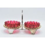 A pair of early 20th century cranberry and vaseline glass preserve dishes with a silver plated