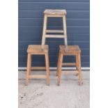 A trio of vintage wooden square school classroom stools. 54cm tall. Good solid stools.