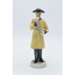 A pottery figure of The Ripon Hornblower by R. Underwood. 19cm tall. In good condition with no