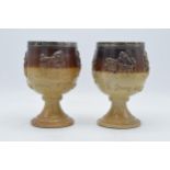A pair of 19th century stoneware goblets depicting traditional hunting and country scenes with