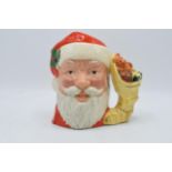 Large Royal Doulton character jug Santa Claus D6690 with sack of toys handle. In good condition with