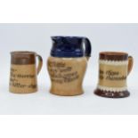 A pair of Doulton Lambeth motto jugs to include 'Heaven helps those who help themselves', 'the