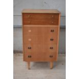 A mid century Limelight tola wood chest of drawers. 68 x 47 x 114cm tall. Missing 2 draw handles. In