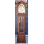 A contemporary oak longcase clock by Interclock, having a glazed trunk door. 165cm tall. Movement