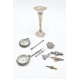 A collection of silver to include a loaded trumpet vase, a .800 watch case, a 0.935 watch case, a