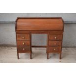 An early to mid 20th century roller top double pedestal desk / bureau with small chair and brass