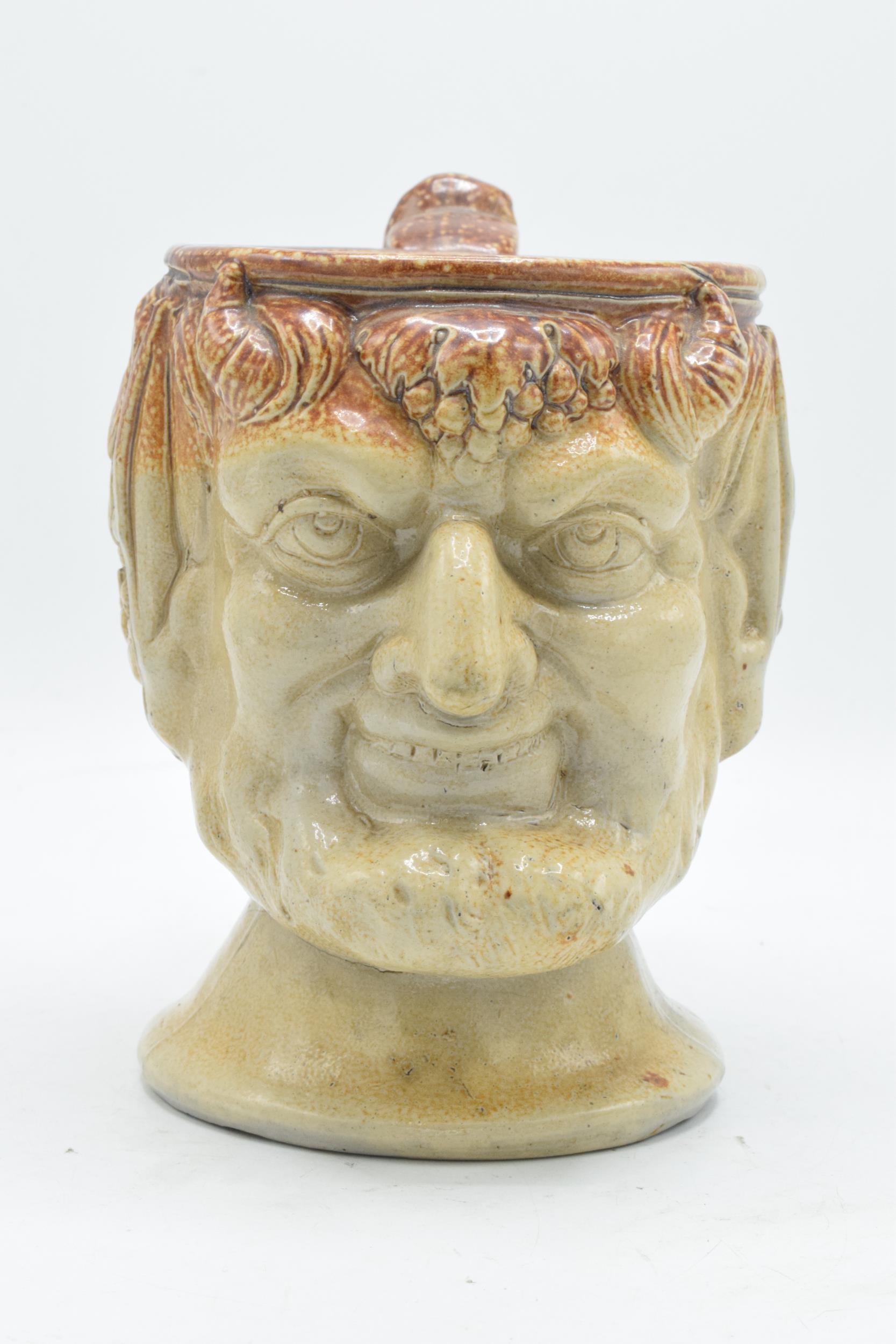 A 19th century stoneware character jug in the form of Bacchus. 19cm tall. Generally in good