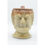 A 19th century stoneware character jug in the form of Bacchus. 19cm tall. Generally in good