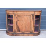 Victorian walnut breakfront credenza with an inlaid panel door flanked by bow glass doors