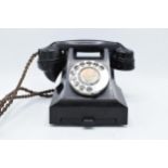 A vintage black Bakelite telephone with '332L TE59 / 2A' to base.