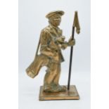 A brass fireside companion set holder in the form of a golfer (only fire poker present). 38cm tall.