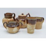 A collection of stoneware to include Doulton Lambeth Queen Victoria 60th Anniversary jug, a silver-
