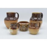 A collection of Royal Doulton and Doulton Lambeth stoneware to include two-tone jugs, a floral