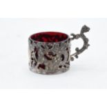 A decorative silver cup with cherub decoration and red glass liner. 28.4 grams. Birm 1903. W