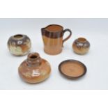 A collection of mainly two-tone stoneware to include a Doulton Lambeth jug for E. Johnson & Co