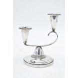 A double-sconce hallmarked silver candlestick. Birmingham 1963. 176.6 grams (loaded). 13cm tall.