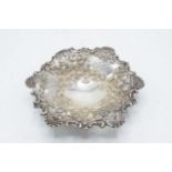 Silver raised bon bon dish on three ball feet with ornate decoration. 89.8 grams. Chester 1908. 16cm