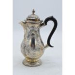 Hallmarked silver ornate coffee pot with floral decoration and ebonised handle. London 1902. Gross