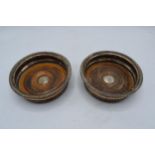 A pair of Victorian silver-plated wine bottle coasters (2).15cm diameter.