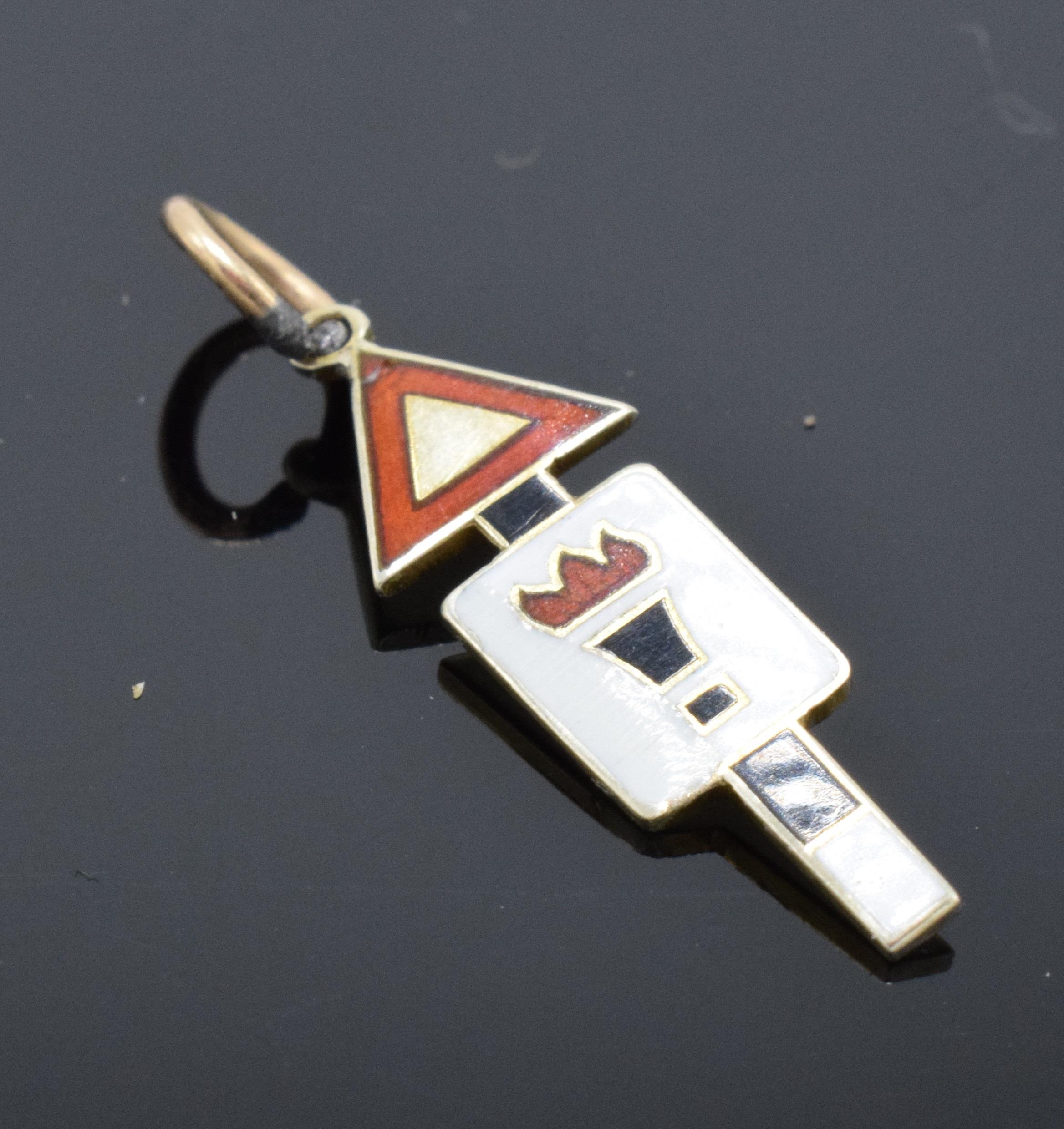 9ct gold enamelled road sign charm 'Torch of Knowledge'. 2cm long.